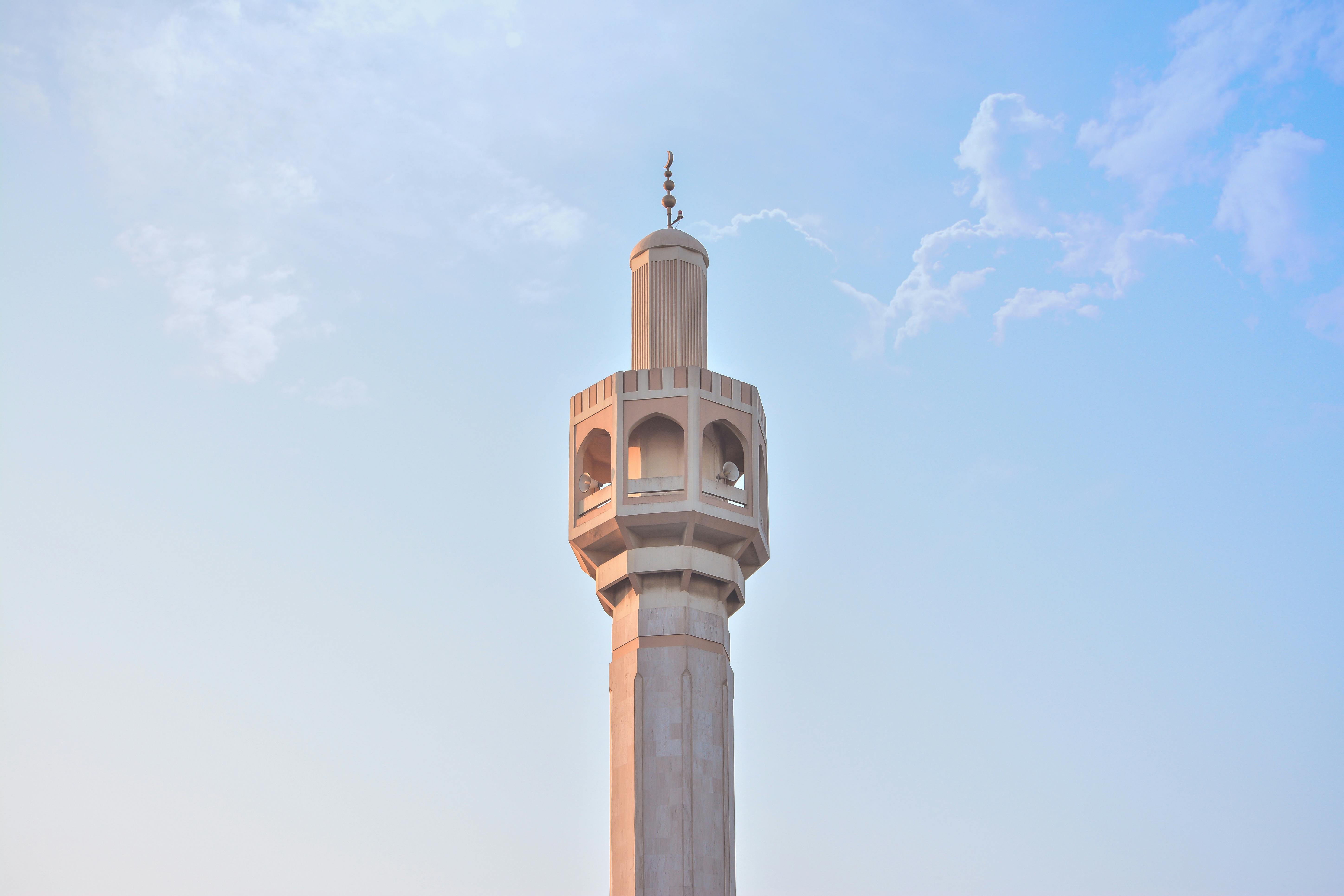 minaret masjid (mosque) from on a sky blue background