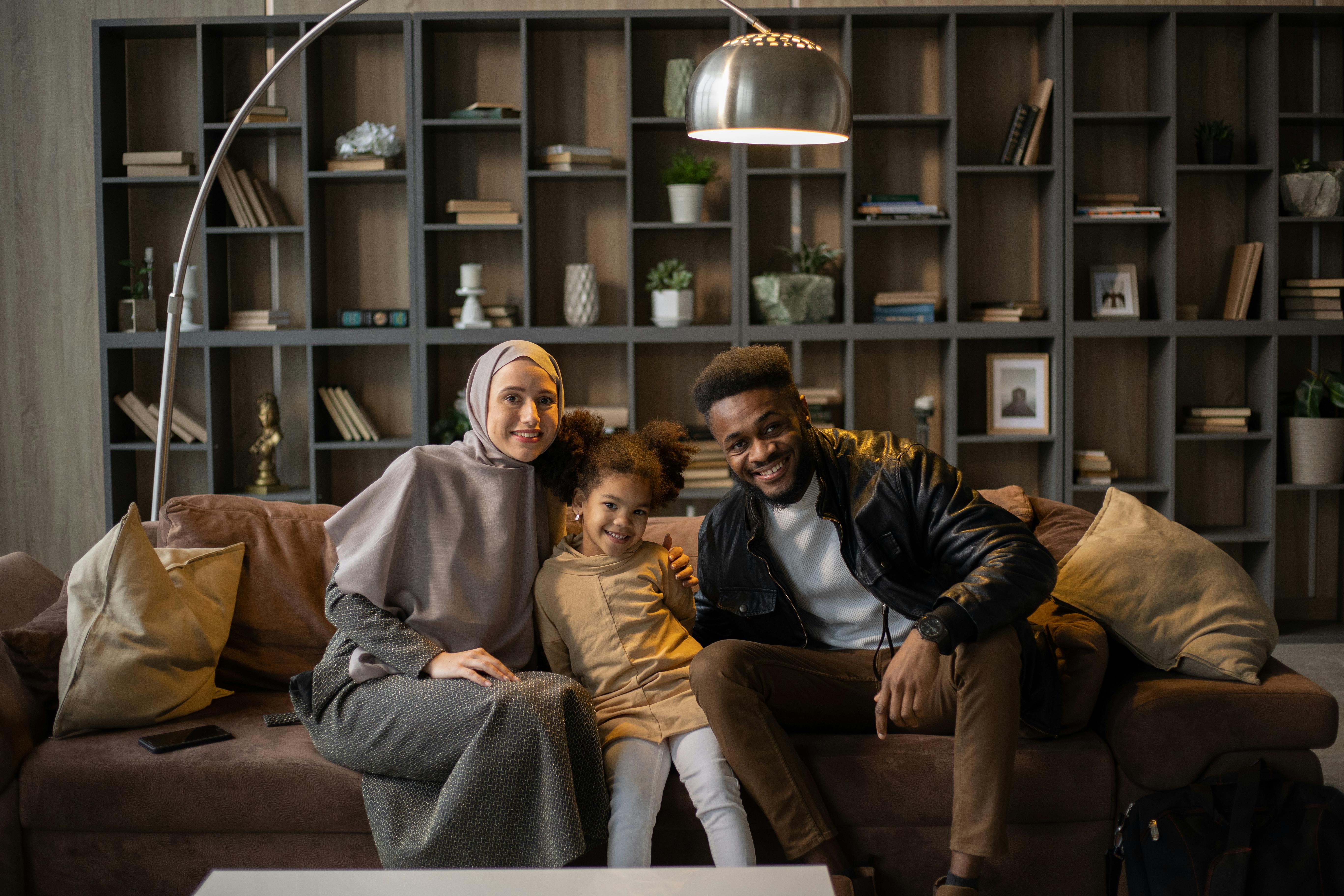 multi-racial muslim family sitting together in a warm cozy room 